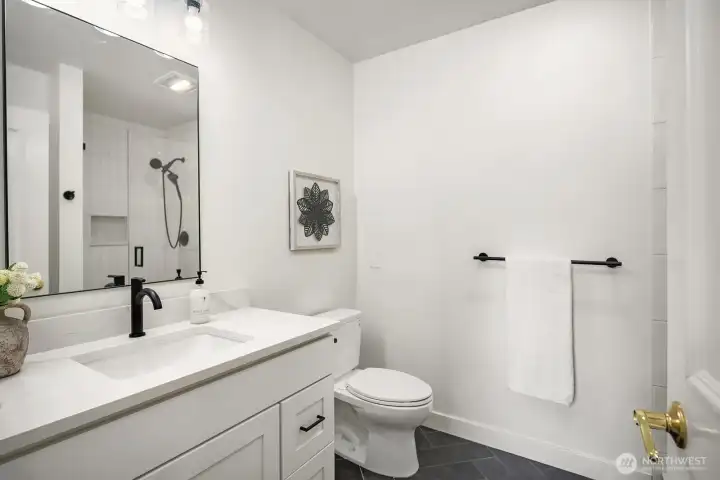 This sleek, freshly remodeled bathroom showcases crisp white walls, a modern floating vanity with matte black fixtures, and clean contemporary finishes throughout. Every detail reflects the thoughtful updates made to elevate the home's style and functionality. This sleek, freshly remodeled bathroom showcases crisp white walls, a modern floating vanity with matte black fixtures, and clean contemporary finishes throughout. Every detail reflects the thoughtful updates made to elevate the home's style and functionality.