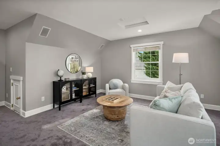 This comfortable and versatile living space features soft neutral tones, plush carpeting, and a charming decorative fireplace that adds character and warmth. Large windows invite natural light while creating a relaxed, inviting atmosphere perfect for everyday living. This comfortable and versatile living space features soft neutral tones, plush carpeting, and a charming decorative fireplace that adds character and warmth. Large windows invite natural light while creating a relaxed, inviting atmosphere perfect for everyday living.