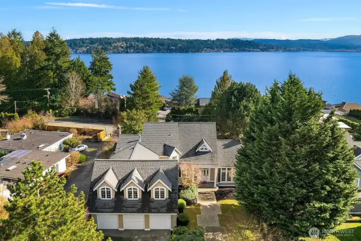 This stunning aerial perspective showcases the home's coveted position within a private 7-home enclave, highlighting the sweeping views of Lake Sammamish that can be enjoyed from multiple levels of the residence. The beautifully landscaped grounds, expansive deck, and lush backyard are all on full display against the breathtaking backdrop of the sparkling lake beyond. This stunning aerial perspective showcases the home's coveted position within a private 7-home enclave, highlighting the sweeping views of Lake Sammamish that can be enjoyed from multiple levels of the residence. The beautifully landscaped grounds, expansive deck, and lush backyard are all on full display against the breathtaking backdrop of the sparkling lake beyond.