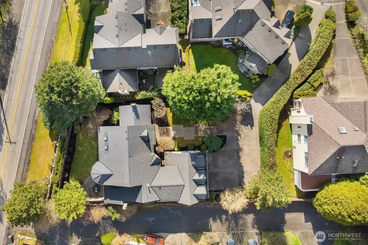 This aerial view perfectly illustrates the home's desirable setting within a quiet, private enclave, surrounded by mature trees and tucked away from the bustle while remaining close to top-rated Bellevue schools, I-90, and neighborhood amenities. The lush, tree-lined streets and well-maintained neighboring homes reflect the pride of ownership that defines this exceptional community. This aerial view perfectly illustrates the home's desirable setting within a quiet, private enclave, surrounded by mature trees and tucked away from the bustle while remaining close to top-rated Bellevue schools, I-90, and neighborhood amenities. The lush, tree-lined streets and well-maintained neighboring homes reflect the pride of ownership that defines this exceptional community.