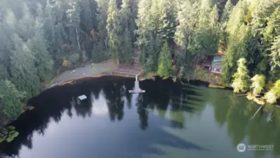 AERIAL OF LOST LAKE LOOKING AT THE CLUBHOUSE, DOCK AND FLOATING DOCK