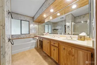 Primary suite bathroom with soaking tub, double sink and window.