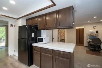 Kitchen features extended counter space, generous cabinets, and a functional eating bar with a view into the family room.