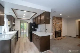 From the kitchen, easily access the family room to the right, complete with a warm gas fireplace for cozy gatherings.