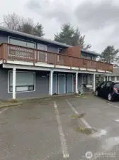 The middle door leads to the unit.  The parking spot is the empty one to the right in this photo.  It's marked '20', but it's hard to read.
