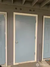 The door leads upstairs to four units at the landing.