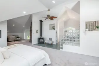 Entire upper level is a dreamy primary suite with a spa-like bathroom, vaulted ceilings, a freestanding gas stove, walk-in closet, new carpet & paint