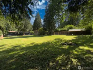 Huge, fully fenced backyard with patio, fire pit area & oversized dog kennel or chicken run.