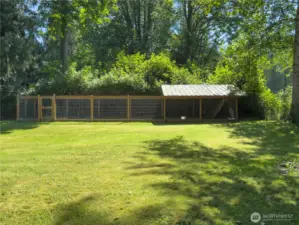 Huge, fully fenced backyard with patio, fire pit area & oversized dog kennel or chicken run.