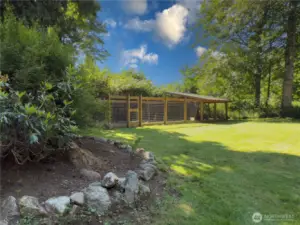 Huge, fully fenced backyard with patio, fire pit area & oversized dog kennel or chicken run.