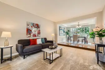 Living area opens to formal dining space. Neutral color palette, detailed trim, and flexible layout ideal for everyday living or entertaining.