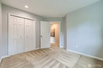Ideal for guests or a home office, this room boasts a spacious double-door closet and recessed lighting.