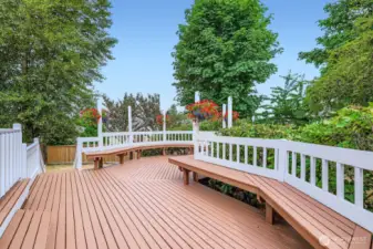 Generous deck design with integrated seating, perfect for gatherings, relaxing, or enjoying backyard views in all seasons.