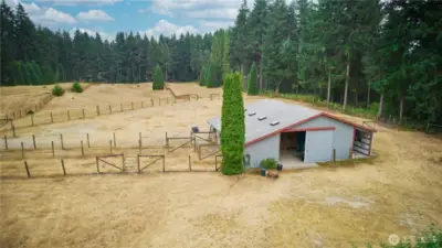 Well-kept 40x40 barn with convenient sliding doors providing smooth access to and from the pastures with extra storage space off to the right.