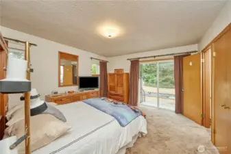 Master bedroom offers spacious comfort, with a half bath featuring enjoyable views and direct access to a private outdoor oasis.