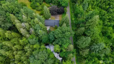 Situated on 5+ acres with a pond and creek