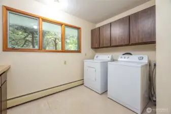 The laundry room is very large with lots of counter space and storage.
