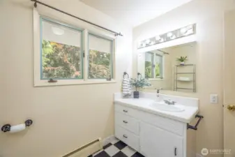The upstairs full bathroom, accessible from the hallway.