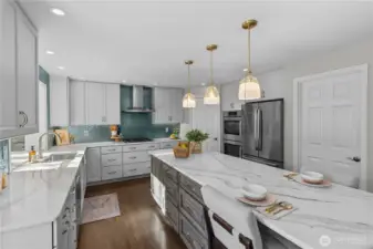 This kitchen is the chef's kiss!  Gas range, quartz counters, huge island, and more