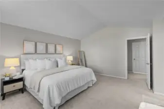 Vaulted ceilings give this bedroom a sense of space