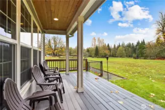 ...through the back doors to the left - bring your morning coffee outside.  Notice the fenced-in dog run already there for your pups!