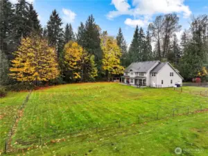 From the side property line - the fence on the left is just to keep the pets in; property extends into the woods to the left.
