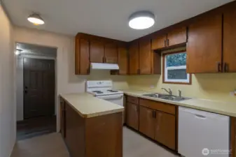 Kitchen with new appliances leads to rear mud room