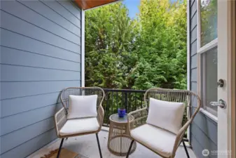 Covered deck backs to trees creating a beautiful and private experience