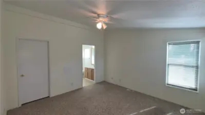 Main bedroom with walk-in closet and attached 3/4 bath.