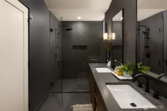 The walk-in shower features two showerheads, one handheld & one rainfall