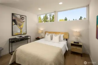 Additional bedroom contains high windows bringing in natural light