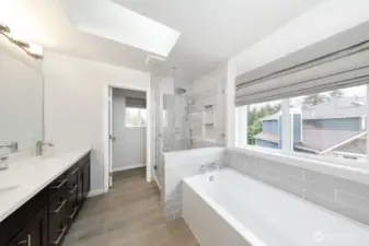 Modern spa-inspired five-piece primary bath with soaking tub, glass walk-in shower, and dual vanity. (Upstairs)