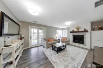 Spacious lower-level rec room with fireplace, backyard access, and excellent income potential.