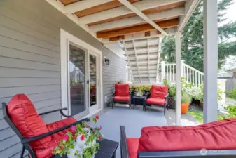 Covered lower-level patio featuring premium decking above and a well-designed gutter system for year-round enjoyment.