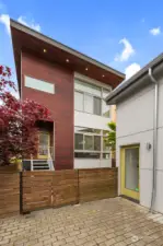 Double gates into the backyard make it easy to bring in large items. Beautiful lighting on the house creates a warm and welcoming feeling every time you come home!