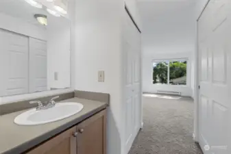 The primary bedroom offers a private vanity area with a sink, providing your own space to get ready outside the main bathroom—perfect for added convenience and privacy.