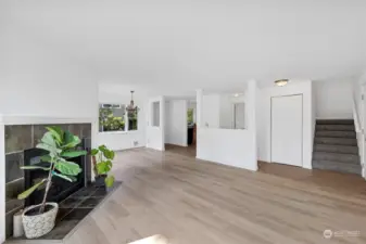 Bright and inviting living room featuring brand-new hardwood laminate flooring, fresh paint, and a modern, open feel—perfect for relaxing or entertaining.