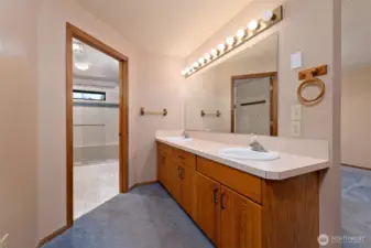 Primary bathroom with 2 sinks, a large step-in shower, and a huge walk-in closet.