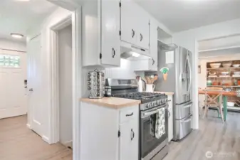 View of the front door entry and the kitchen,