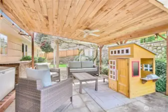 Covered patio with ceiling fan, perfect for summer entertaining.