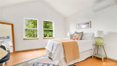 Vaulted ceilings in the primary bedroom and big windows let in so much light!