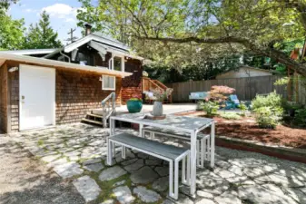 The no-lawn-maintenance park-like backyard will turn you into the perfect host. An all-seasons wonderland with backyard BBQs all summer and toasty s’mores all winter! Note that the door leads to the lower-level primary bedroom.