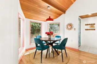 The dining room is surrounded by nature—morning coffee in the breakfast nook with flowers blooming and birds chirping is something the seller will miss dearly.