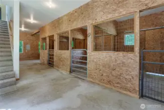 Refreshed barn with 3 stalls. Stairs lead to living quarters.