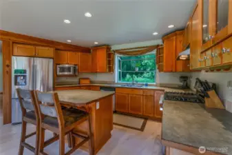 Spacious kitchen with ample cabinets and counter space. Stainless steel appliances, including propane range.