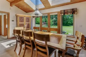 Large dining area with more windows and skylights, allowing for lots of natural light.