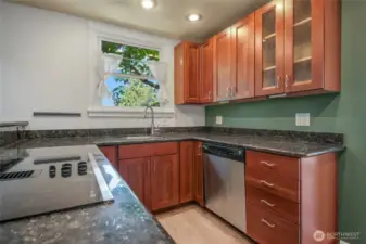 Kitchen is open to the great room. There's a pantry and a storage area nearby.