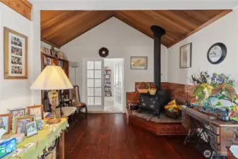 Vaulted ceilings leading to the main level primary bedroom through the french doors