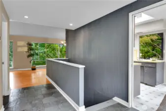 Slate entry, vaulted ceilings, hardwood floors in living and dining areas.  Stairs to lower level utility room.