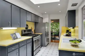 Natural gas range, double sink in kitchen.